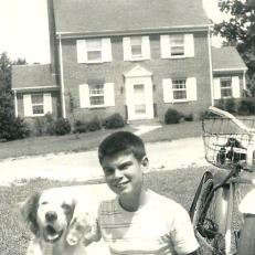 Ray Wallace, Jr., returning from a paper route, poses with “Joe”, the most popular member of the Wallace family….South Crestwood Ave. in the background.